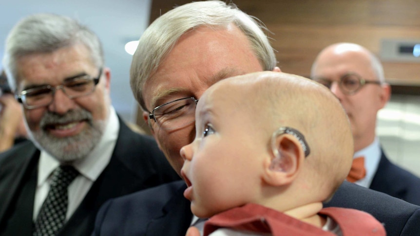 Kevin Rudd holds young Patrick Wilkinson