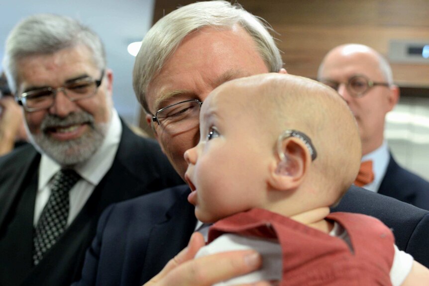 Kevin Rudd holds young Patrick Wilkinson