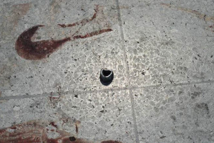 A photo published by the New York Times of a nut that may have been used as shrapnel next to some blood.