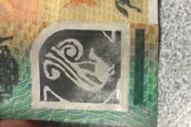 Part of a counterfeit $100 note.