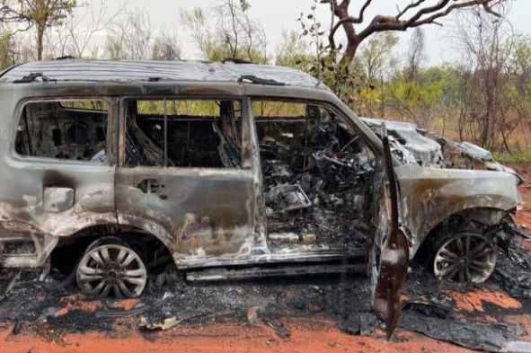 A burn car in bushland.