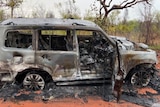 A burn car in bushland.