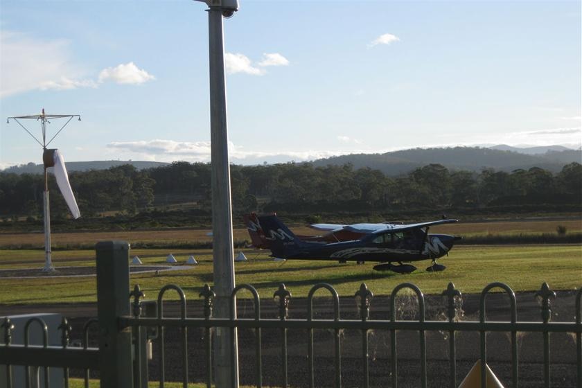 A small plane lands at a regional airport.