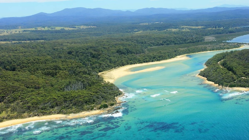 an aerial shot of a river inlet