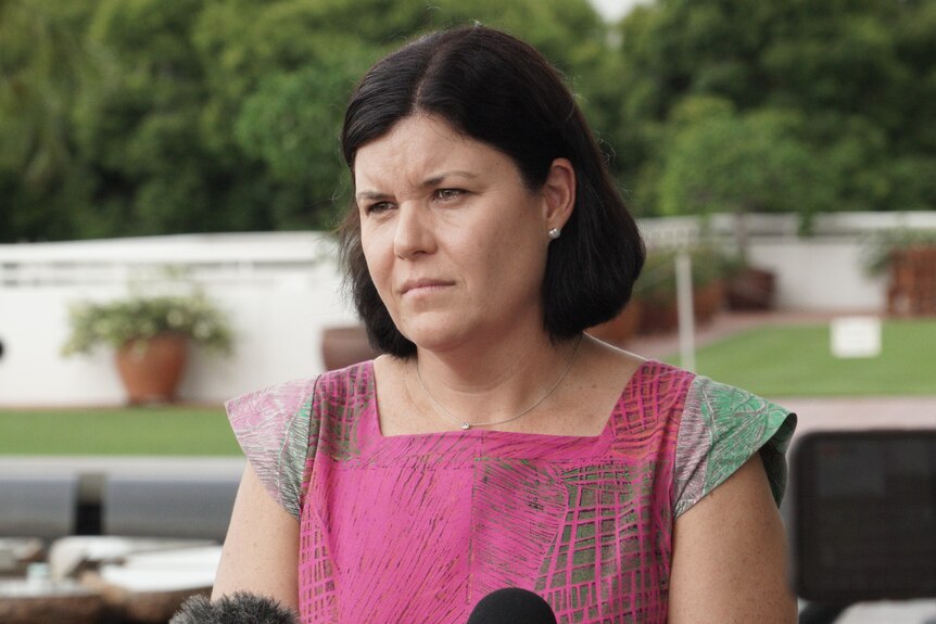NT Health Minister Natasha Fyles stands outside Parliament House wearing a colourful top.