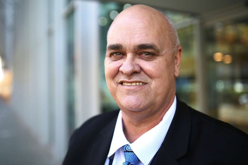 A head and shoulders shot of WA Police Aboriginal Affairs Superintendent Brian Wilkinson outside posing for a photo.