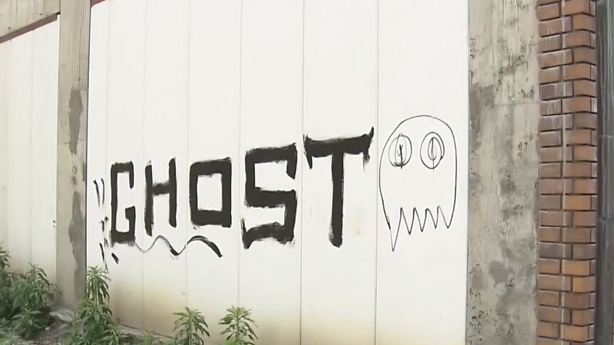 A graffiti tag on a white wall reading "ghost"