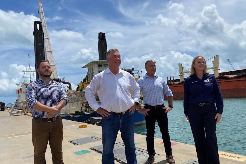 Four men and one woman standing at a dock at port in Townsville