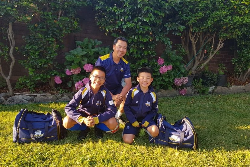 A man in soccer strip with some small children