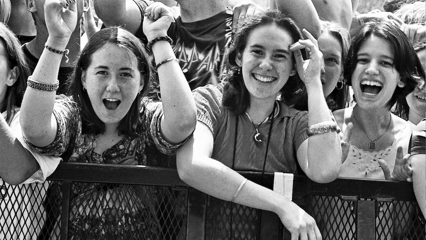 A black-and-white photo of three cheering woman during the first Big Day Out in Sydney.