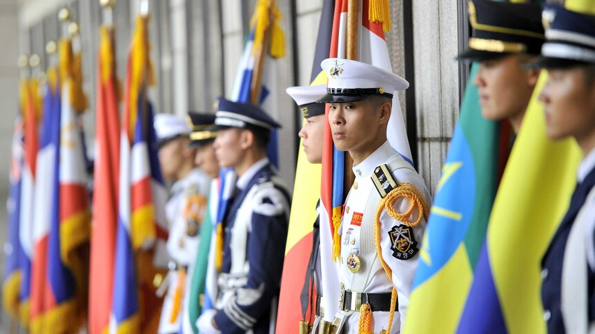 South Korean honour guards stand in front of a war memorial July 27, 2013