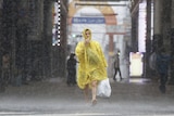 man walks in rain japan typhoon