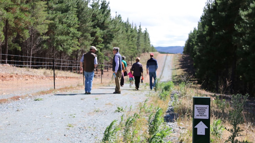 A group makes their way down the memorial walking track.