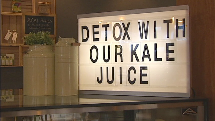 Sign in a health food shop advertising kale juice, popular in fad diets.