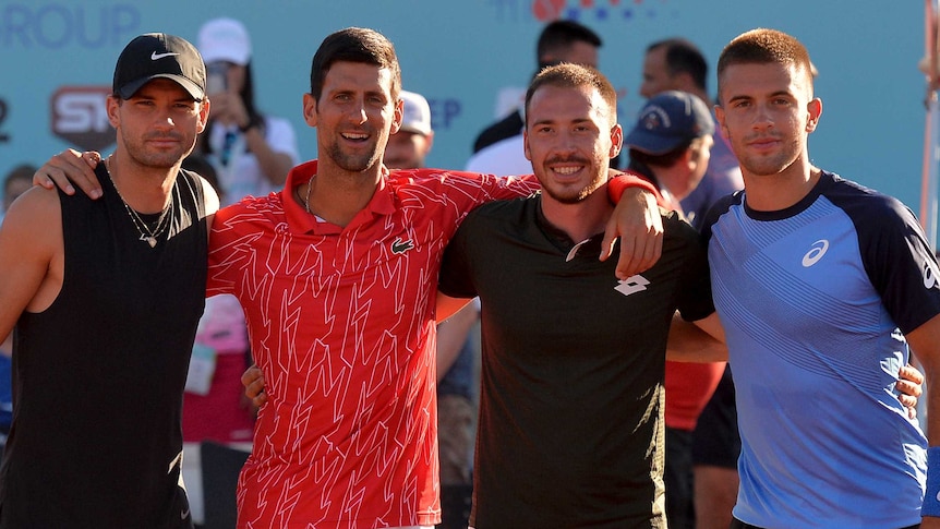 Grigor Dimitrov, Novak Djokovic, Pedja Krstin and Borna Coric pose for a photo on court