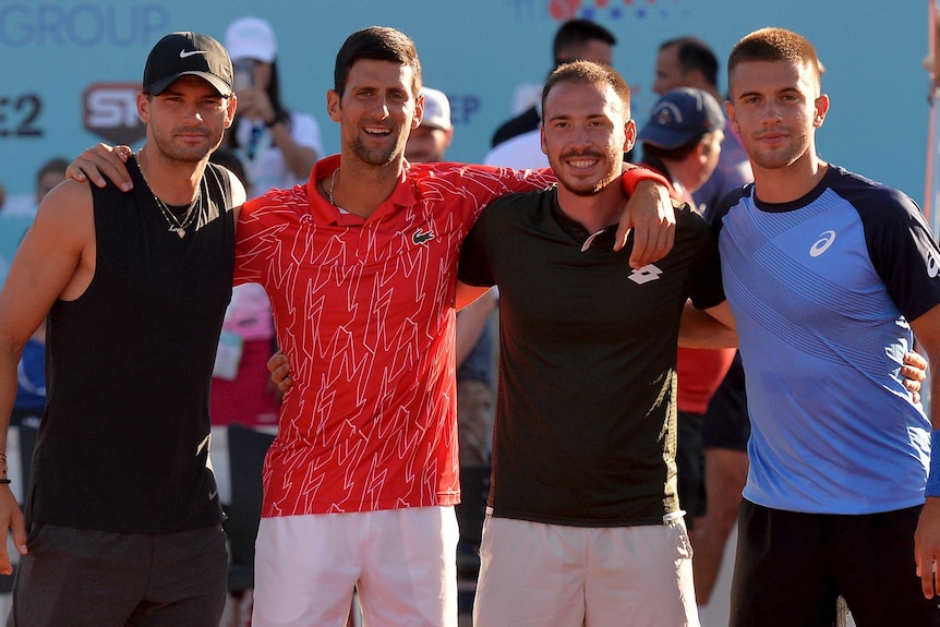 Grigor Dimitrov, Novak Djokovic, Pedja Krstin and Borna Coric pose for a photo on court