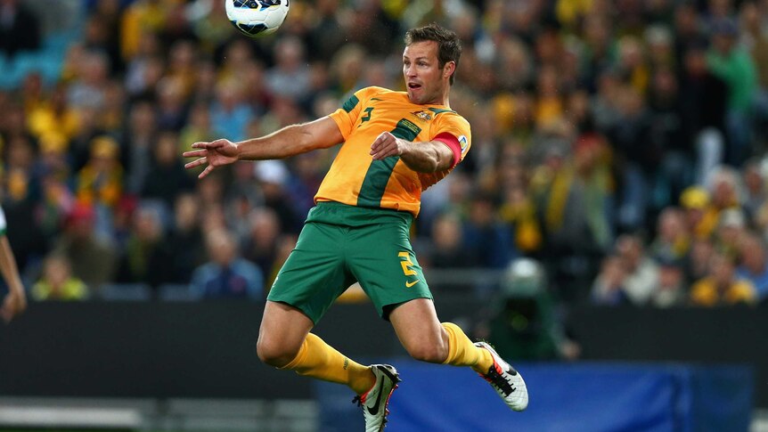 Socceroos possession ... Lucas Neill chests a ball