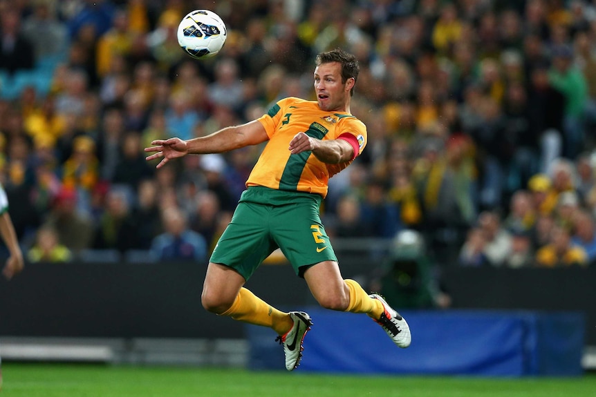 Socceroos possession ... Lucas Neill chests a ball