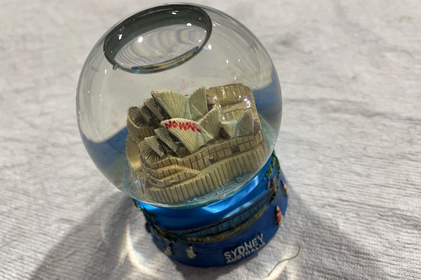 A Sydney Opera House snow globe with 'no war' written on the sails. 