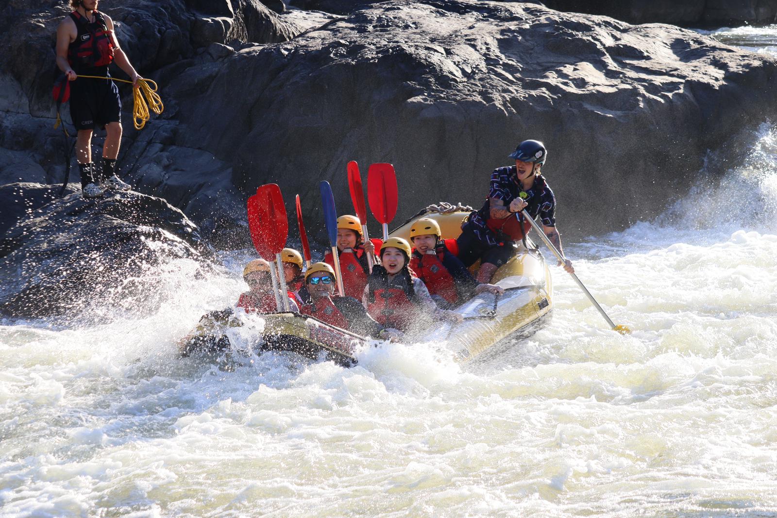 Tourists take part in a white water rafting trip.