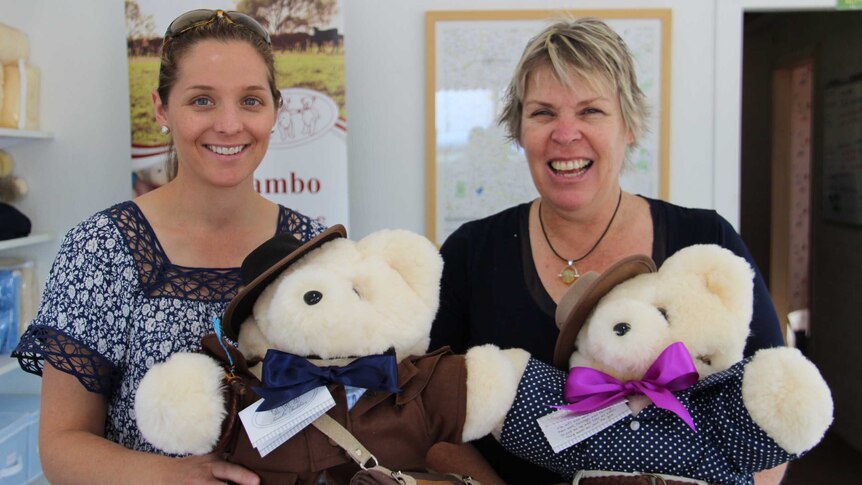 two women holding teddy bears