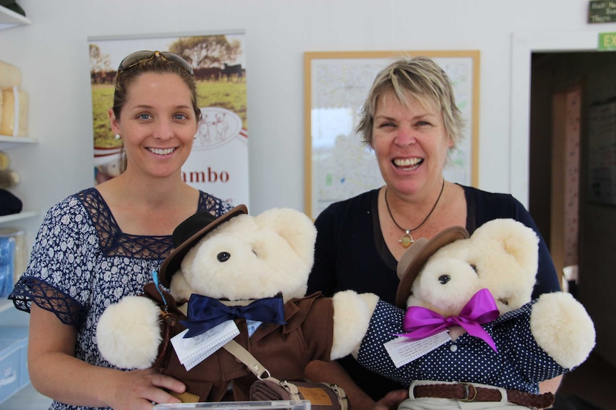 two women holding teddy bears