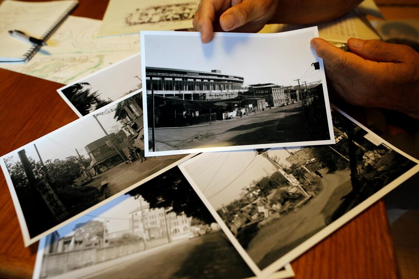 Mr Jinno shows his old photos of the previous national stadium neighbouring his house in Tokyo.