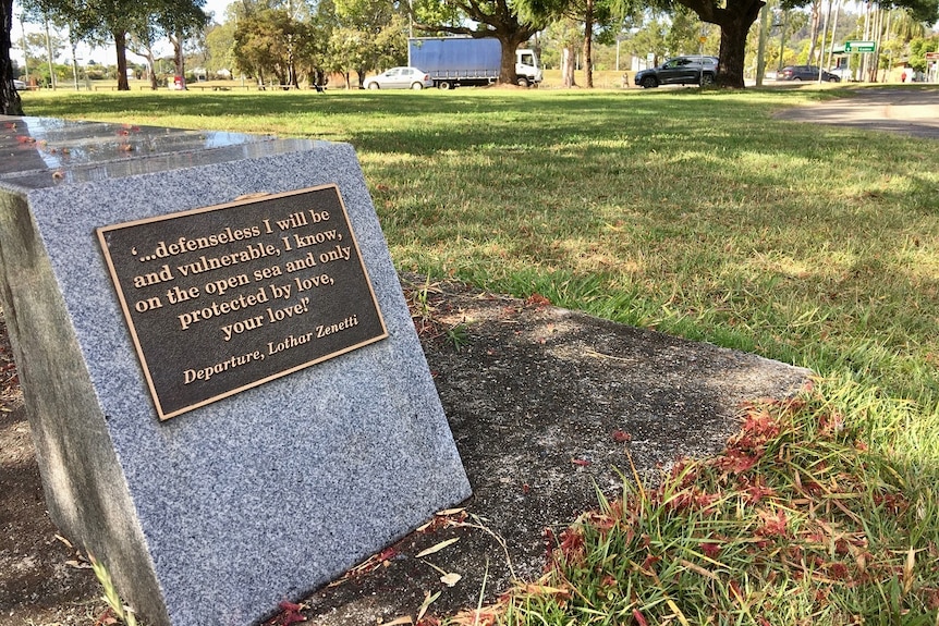 A granite seat under a tree in Lismore, bearing a plaque featuring Simon's favourite quote.