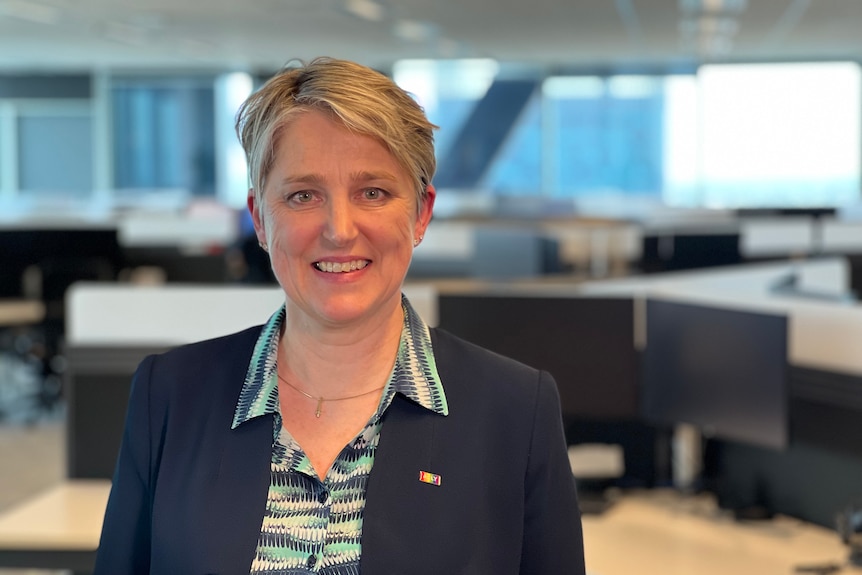 Laura Tyler, chief technical officer at BHP stands in an office building.