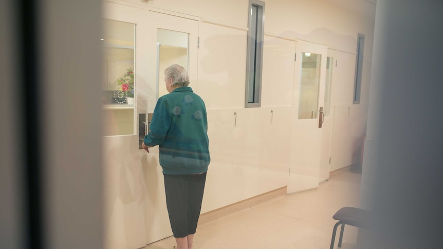 A woman closes the living room doors.