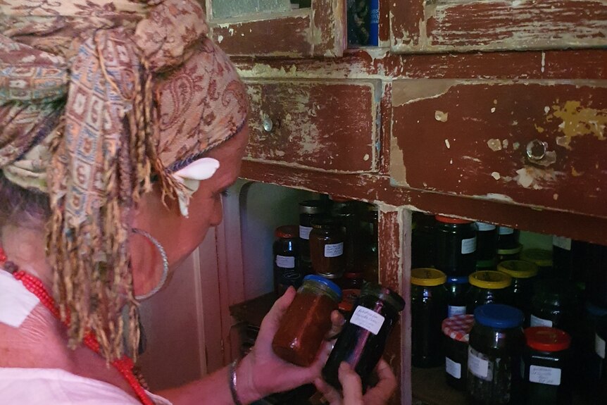 Lady holding homemade jars of jam