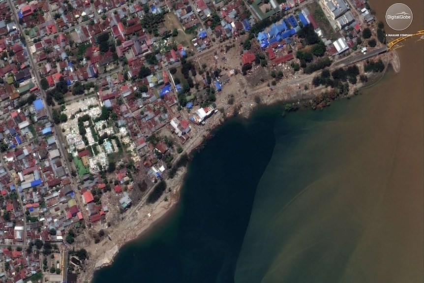 This October 1, 2018, satellite photo provided by DigitalGlobe shows a view of the waterfront near the bridge in Palu, Indonesia.
