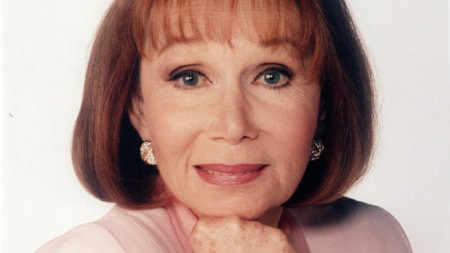 Katherine Helmond in pink, wearing sparkling jewellery and looking straight into the camera and smiling