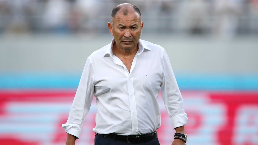 England's rugby union coach stands with his arms folded as he watches a practise scrum at the Rugby World Cup in Tokyo.