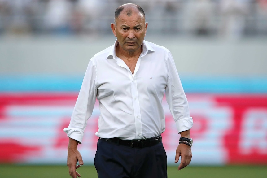 England's rugby union coach stands with his arms folded as he watches a practise scrum at the Rugby World Cup in Tokyo.