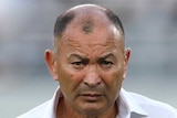 England's rugby union coach stands with his arms folded as he watches a practise scrum at the Rugby World Cup in Tokyo.