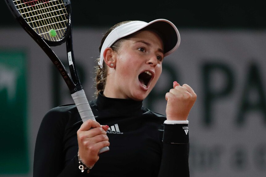 Jelena Ostapenko clenches her fist and lets out a scream.