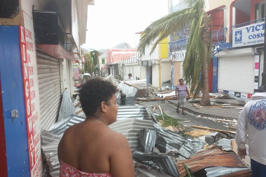 Residents inspect the damage along a central street in Saint Martin after Hurricane Irma.