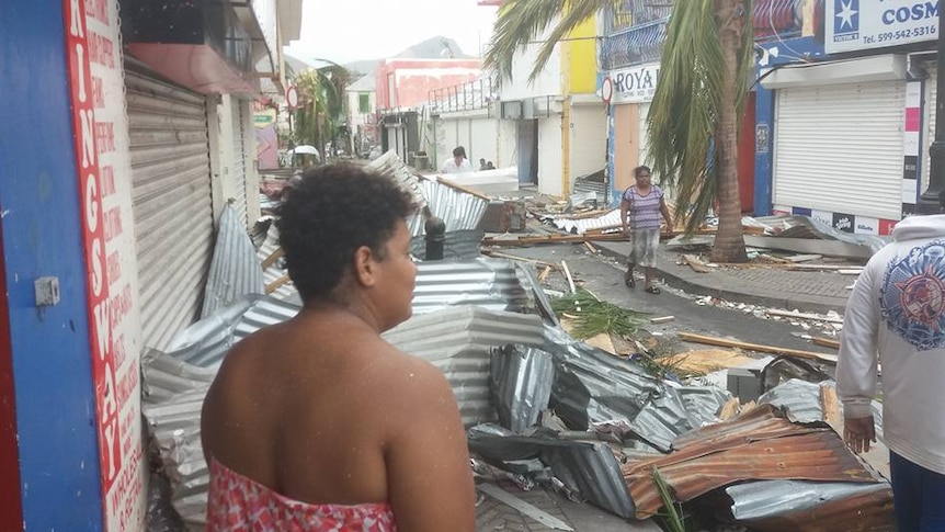 Residents inspect the damage along a central street in Saint Martin after Hurricane Irma.