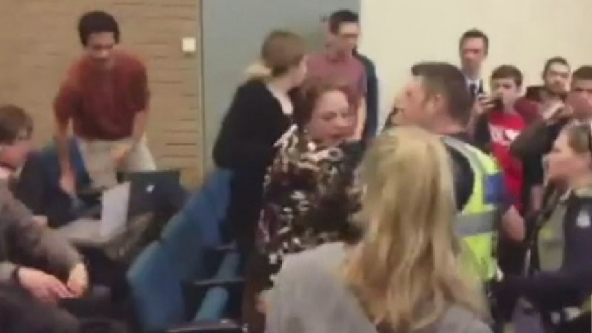 Police escort former Liberal MP Sophie Mirabella out of a lecture at Melbourne University.