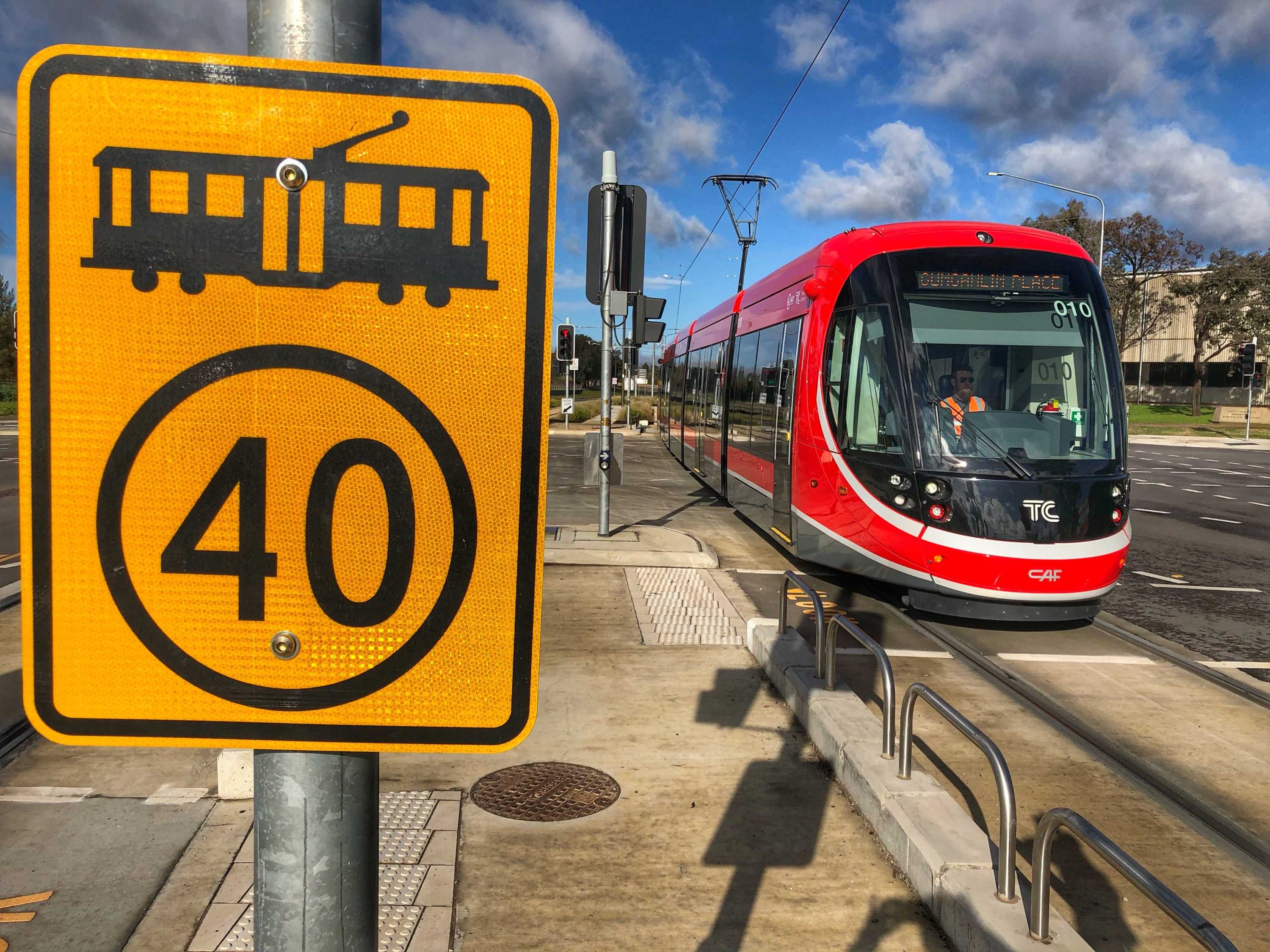 A light rail vehicle sits at an intersection in Canberra.