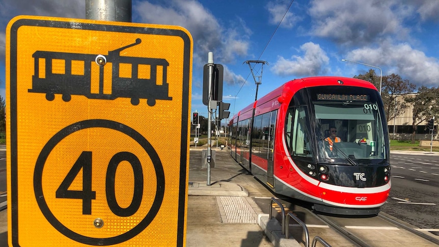 A light rail vehicle sits at an intersection in Canberra.