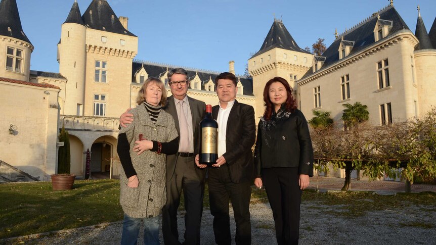 Lam Kok (second from right) celebrates his purchase of the Chateau de La Riviere on Friday.