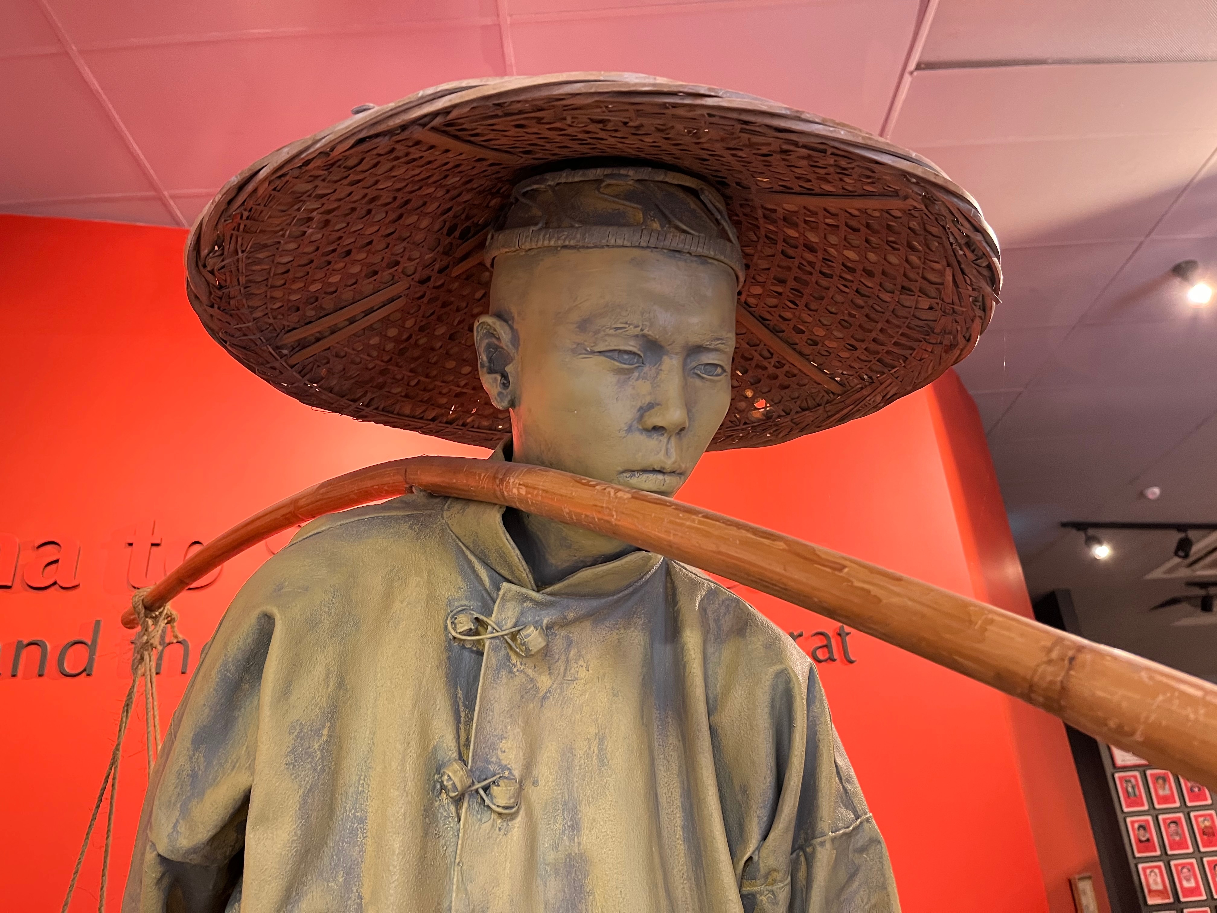 A closeup of a lifelike sculpture of a Chinese miner at the Gum San centre