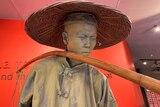 A closeup of a lifelike sculpture of a Chinese miner at the Gum San centre