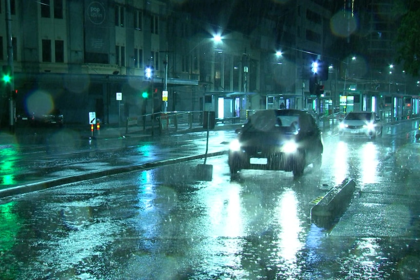 Rain on a road at night.