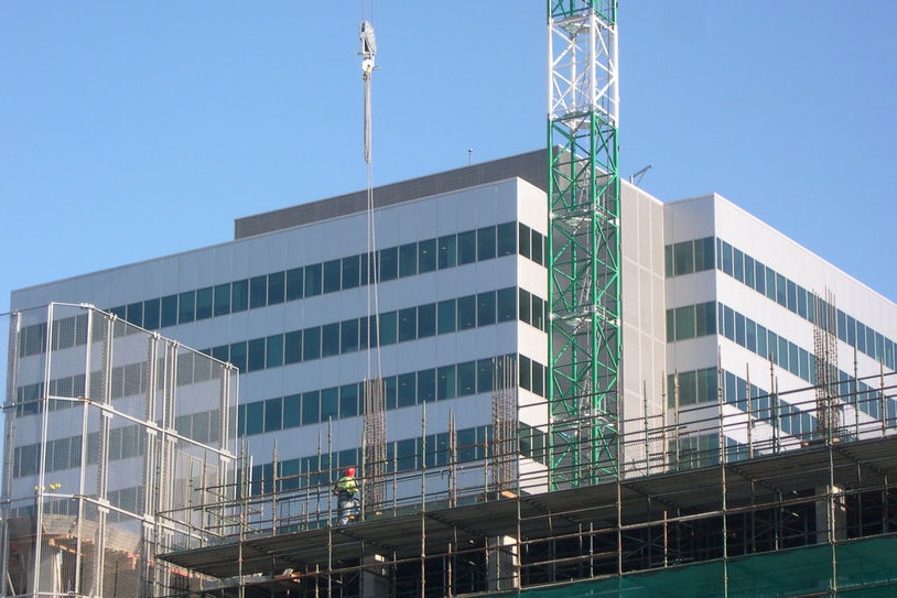 Worker on building site with crane Canberra - generic construction