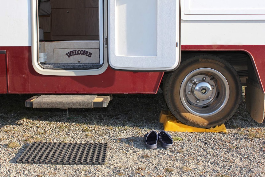 A welcome sign on the steps of a motorhome.