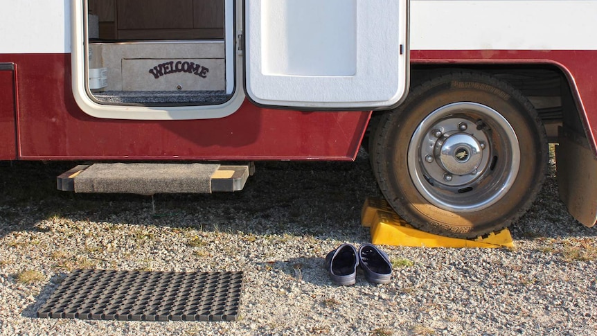 A welcome sign on the steps of a motorhome.