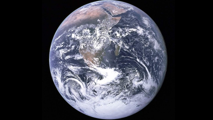 Planet Earth pictured against a black sky as seen from the command module of the Apollo 17 moon mission in 1972